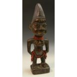 Tribal Art - Yoruba Ibeji figure, she stands, adorned with beads, her coiffure picked out in blue,