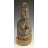 Tribal Art - a Senufo feamale bust, carved stylized scarified features, rustic circular base,