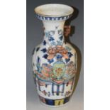 A Chinese ovoid vase, painted in polychrome with a scholar's table,