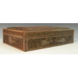 An Indian sandalwood box, profusely carved with buta, stylised flowers and dense scrolling foliage,