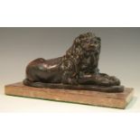 A bronzed library model, of a recumbent lion, rectangular marble base, 25.
