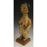 Tribal Art - a West African maternity figure, possibly Akan, Ghana, she squats, holding her breast,