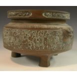 A large Chinese bronze ding censer, cast in relief with bands of lotus, flowerheads and dragons,
