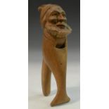 A Black Forest novelty nut cracker, carved as the head of a bearded man, 17.5cm long, c.