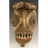 Tribal Art - a Gurunsi zoomorphic mask, stylised features and bared teeth,