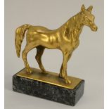 A gilt metal equestrian desk weight, cast as a standing horse, marble base, 9.