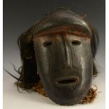 Tribal Art - an African mask, simplified features beneath an over-hanging forehead,