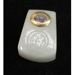 An Indian gold coloured metal and amethyst mounted jade pendant or amulet, carved with a roundel, 2.