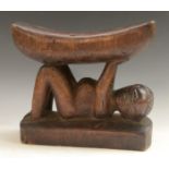 Tribal Art - an African headrest, probably Luba, the support carved as a reclining figure, 22.