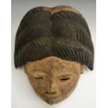 Tribal Art - a Yoruba mask, leiptical features, substantial and highly stylised coiffure, 32cm long,