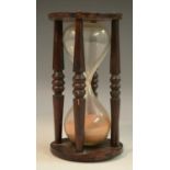 Treen - an oak hour glass, turned pillars, 17cm high,