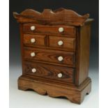 A Victorian pitch pine miniature chest of drawers,