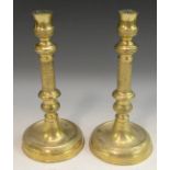 A pair of French Empire gilt brass table candlesticks, urnular sconces,