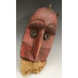 Tribal Art - a Dan mask, domed forehead set with wrought iron scrolls,