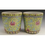 A pair of Chinese tapered cylindrical jardinieres, brightly painted with chrysanthemums,