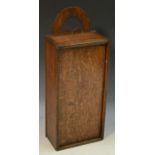 A George III oak candle box, pierced arched cresting above a sliding cover,