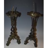 A pair of Chinese bronze tripod pricket altar candlesticks,