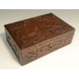 An Indian hardwood rectangular box, hinged cover carved with a peacock,