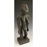 Tribal Art - an African figure, probably Luba, she stands, with arms to sides, traces of pigment,