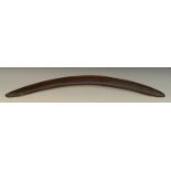 Tribal Art - an Australian Aboriginal boomerang, stone-carved with ridges and textured patterns,