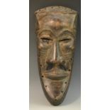 Tribal Art - an African mask, of concave slightly shield-shaped outline, pronounced forehead,