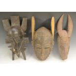 Tribal Art - a Baule zoomorphic mask, tall ears, narrow features, 37cm long, Ivory Coast; another,