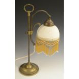 A brass adjustable reading lamp, lithophane shade, lotus-grasped posted loop handle, circular base,