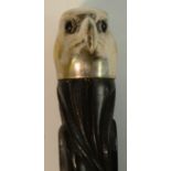 A novelty walking cane, the silvered pommel as the head of a bird, carved ebony shaft,