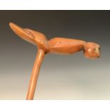 Tribal Art - an African staff, the T-shaped terminal carved as a highly stylised bird, 84cm long,