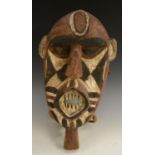 Tribal Art - a Gurunsi Eleo mask, pronounced forehead, navette shaped mouth open and showinf teeth,