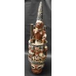 Tribal Art - a large Yoruba Epa mask, carved as a female figure holding a club and a rooster,