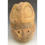 Tribal Art - a Yoruba mask, domed cresting carved with a snake, 28cm long,