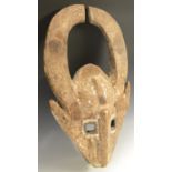 Tribal Art - an African zoomorphic mask, lofty horns curved to the centre,