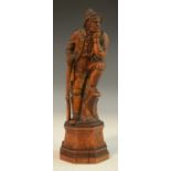 A 19th century Black Forest softwood carving, of a Tyrolean hunter, octagonal base,