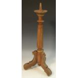 A 19th century parcel gilt pricket candlestick, fluted pillar, shaped tripod base,
