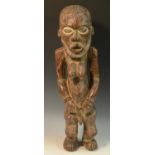 Tribal Art - an African figure, hermaphroditic physiology, the eyes picked out with white pigment,