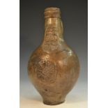 A 17th century grey/brown salt glazed stoneware bellarmine,