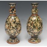 A pair of Doulton Lambeth ovoid vase, painted with scrolling foliage, on an olive ground, 29cm high,