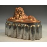 A 19th century copper and tin novelty jelly mould, as a recumbent lion,