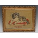 A 19th century Berlin woolwork picture, of a dog, Tobby (sic), the spaniel sits upon a cushion, 21.