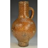 A 16th/17th century tiger glaze stoneware bellarmine, loop handle, 22cm high, c.