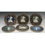 A pair of Thomas Fradley circular plates, applied in white relief with cherubs on a cart,