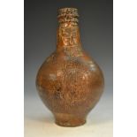 A 17th century tiger glaze stoneware bellarmine, bearded mask above a stylised floral medallion,