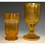 A 19th century Bohemian amber glass octagonal goblet, etched and engraved with Black Forest game,