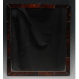 A 19th century tortoiseshell looking-glass, rectangular mirror plate, the frame veneered,