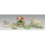 An 18th century Staffordshire creamware recumbent sheep, leaf moulded green base, 14.5cm wide, c.