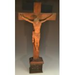 A large 19th century French boxwood Corpus Christi, oak crucifix and pedestal,