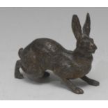 A 19th century cold painted spelter hare, ears perked, 9cm wide, c.