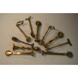 A collection of 19th century brass pastry jiggers, various forms, the largest 13.