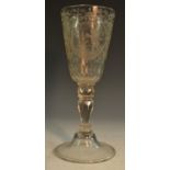 A 19th century Bohemain glass goblet, etched and engraved with roundels of amorini,